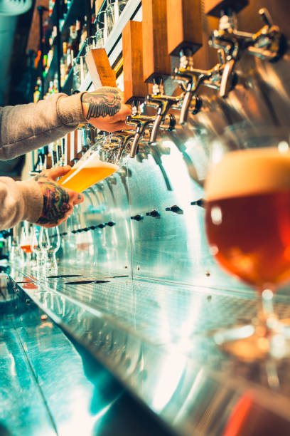 istock Hand of bartender pouring a large lager beer in tap 922962362