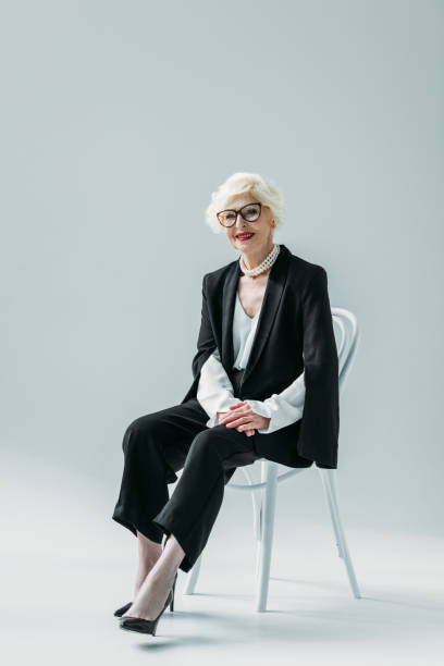 istock elegant senior lady in black suit 922965140