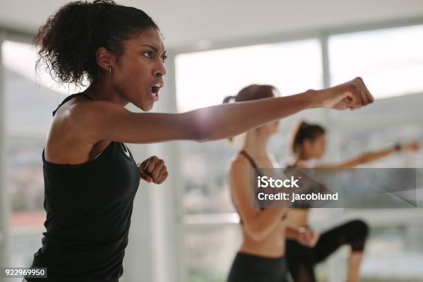 Strong Young Females Exercising In Gym Stock Photo - Download Image Now - Effort, Women, Exercising