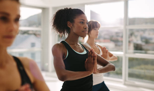 istock Women practices yoga in class 922972378