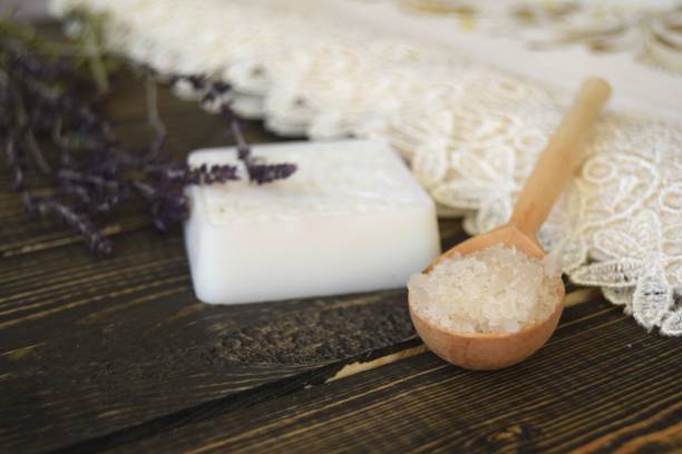istock Salt and soap with herbs on wooden background 922973536