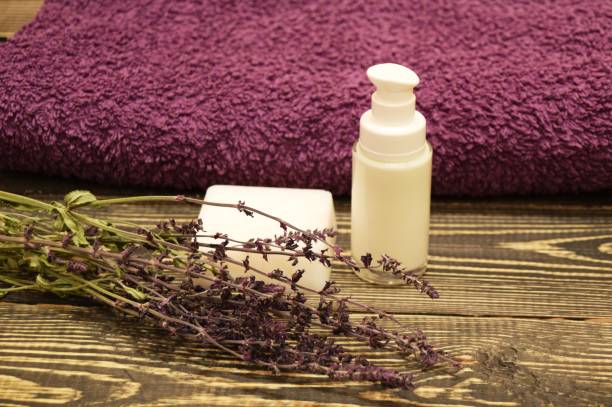 istock Handmade soap with herbs and towel on wooden background 922973538