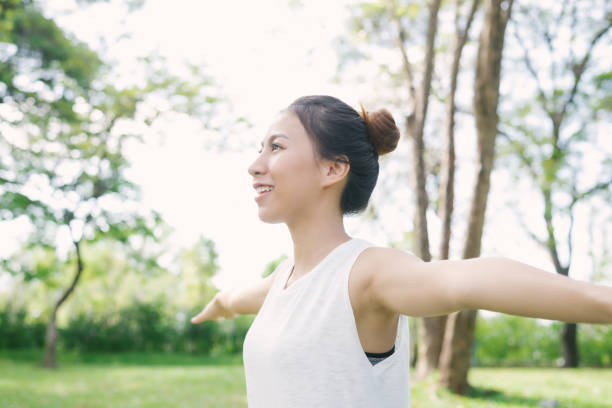 istock Young asian woman yoga outdoors keep calm and meditates while practicing yoga to explore the inner peace. Yoga and meditation have good benefits for health. Yoga Sport and Healthy lifestyle concept. 922988472