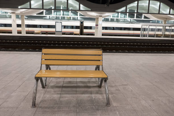 istock wooden seat at the train station 922991902