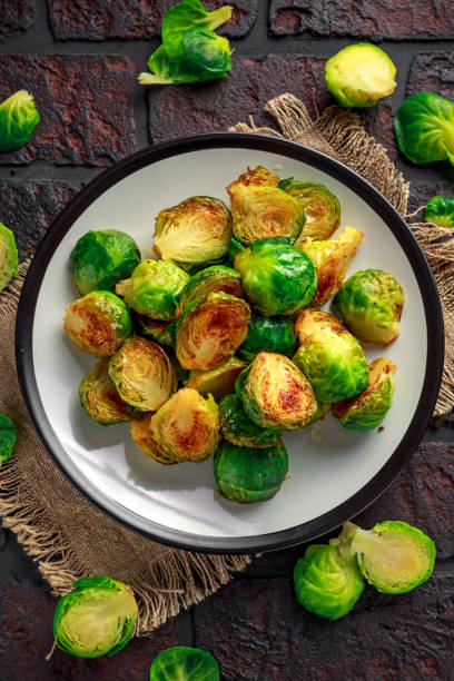 istock Homemade Roasted Brussel Sprouts with Salt, Pepper on a old stone rustic table 922992628