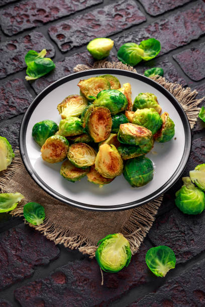 istock Homemade Roasted Brussel Sprouts with Salt, Pepper on a old stone rustic table 922992684