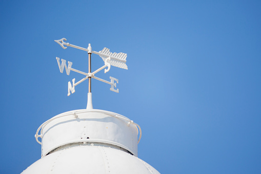 White weather vane on the roof of the Paphos Lighthouse