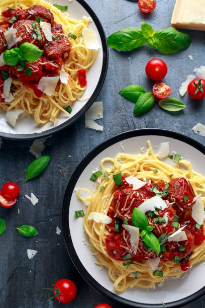istock Spaghetti pasta meatballs with tomato sauce, basil, herbs parmesan cheese on dark background 922993022