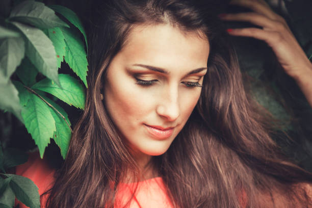 istock Happy beautiful young woman in spring blossom park. 922999528