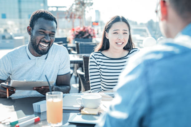 istock Friendly young people joking while having lunch together 923007168