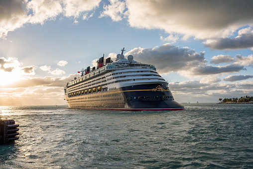 Key West, Florida: December 10, 2017: Walt Disney Cruise line ship departing in Key West, Florida. Walt Disney Company operates four different cruise lines for its guests.