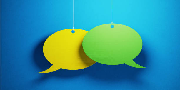 Chat Concept - Colorful Chat Bubbles Over Blue Background Yellow and green colored chat bubbles over blue background. Horizontal composition with copy space. Great use for online messaging concepts. green word bubble stock pictures, royalty-free photos & images