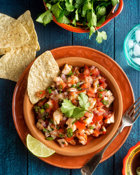 Lobster Ceviche A plate of delicious lobster ceviche with lime, cilantro and corn chips seviche photos stock pictures, royalty-free photos & images