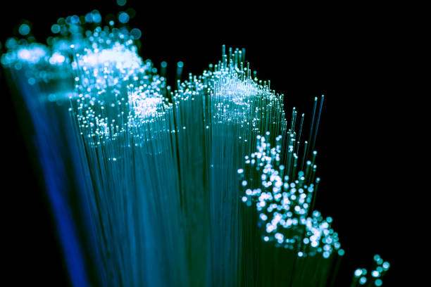 istock Close up of shiny light blue fiber optics background, communication technology 923017866