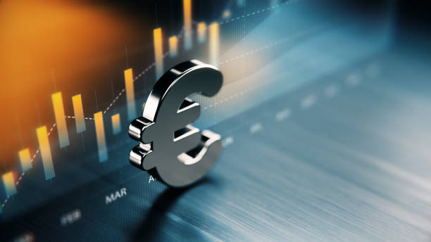 European Union Currency Symbol Standing On Wood Surface In Front Of A Graph European Union currency symbol standing on wood surface in front of a graph. Selective focus. Horizontal composition with copy space. european currency stock pictures, royalty-free photos & images