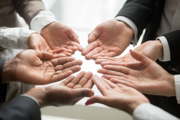 istock Diverse multi-ethnic business team members join hands together palms up 923018896