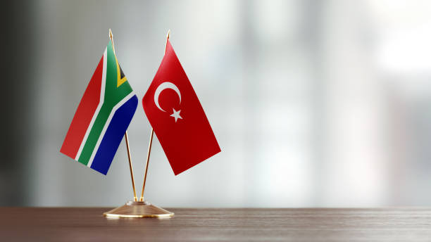 istock Turkish And South African Flag Pair On A Desk Over Defocused Background 923023796