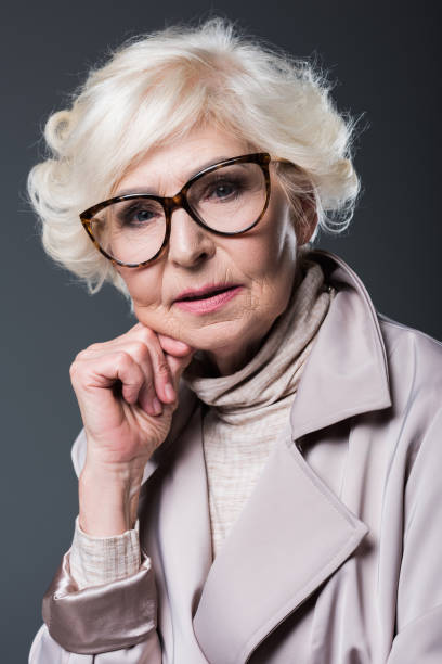 istock senior lady in trench coat 923027506