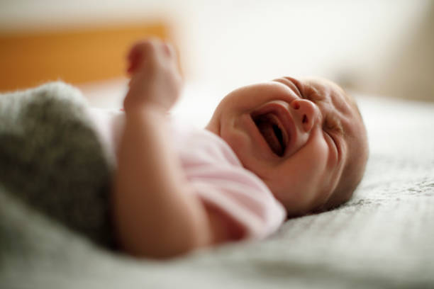 istock Newborn baby girl crying 923028152