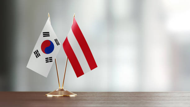 istock South Korean And Austrian Flag Pair On A Desk Over Defocused Background 923028458