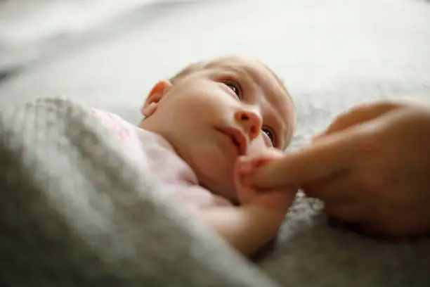 Photo of Newborn baby holding mother's hand