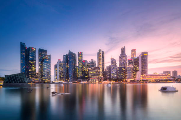 Downtown district and Marina bay in Singapore View of downtown district and Marina bay skyline with purple sunrise in Singapore singapore photos stock pictures, royalty-free photos & images