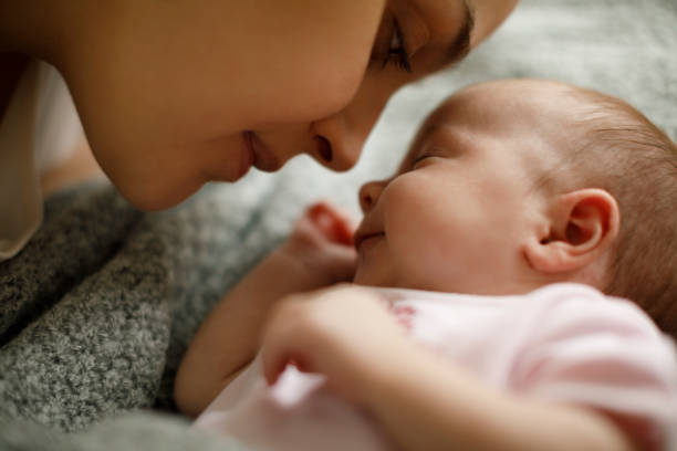 istock Mother and baby playing in the bed 923032034
