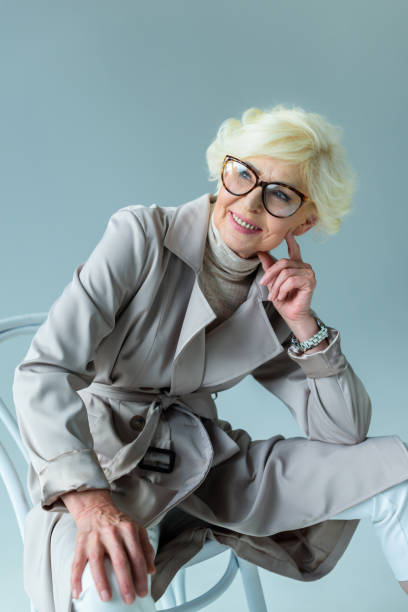 istock senior woman in trench coat 923032448