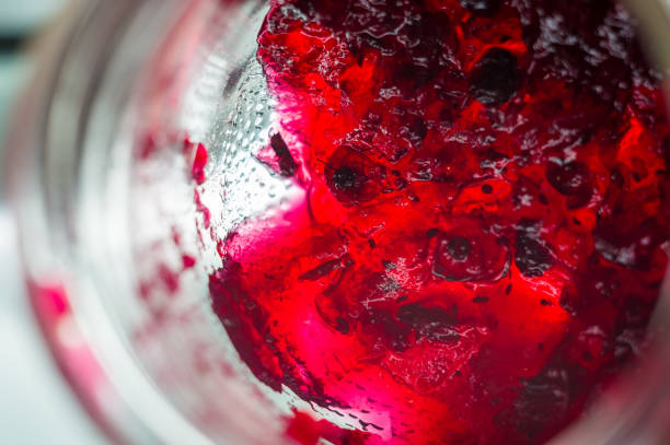 istock Bright translucent red currant jam in a glass jar 923034884