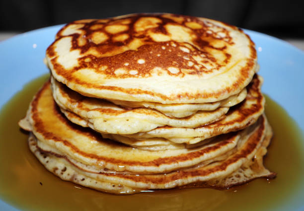 istock Stack of Golden Pancakes Doused in Maple Syrup 923038560