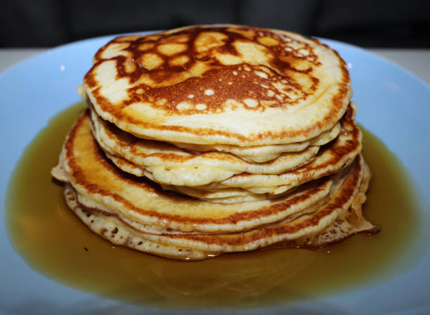 istock Stack of Golden Pancakes Doused in Maple Syrup 923038676
