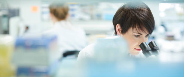 female scientist in a busy research lab