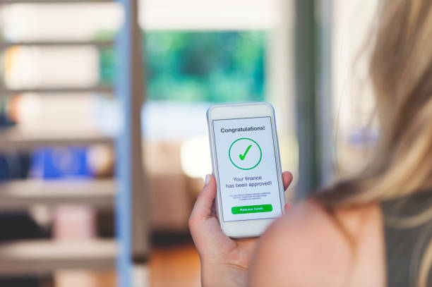 istock Mortgage Loan approval on mobile phone in a house. 923038894