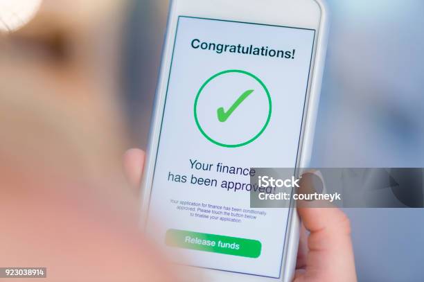 Mortgage Loan Approval On Mobile Phone In A House Stock Photo - Download Image Now - Financial Loan, Agreement, Endorsing