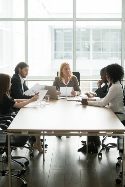 istock Businesswoman discussing project with diverse partners group at office briefing 923039644