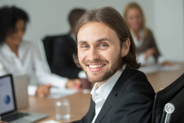 istock Smiling attractive young businessman in suit looking at camera, headshot 923039648