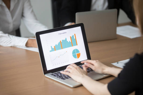 istock Female manager working on laptop at meeting analyzing project statistics 923039662