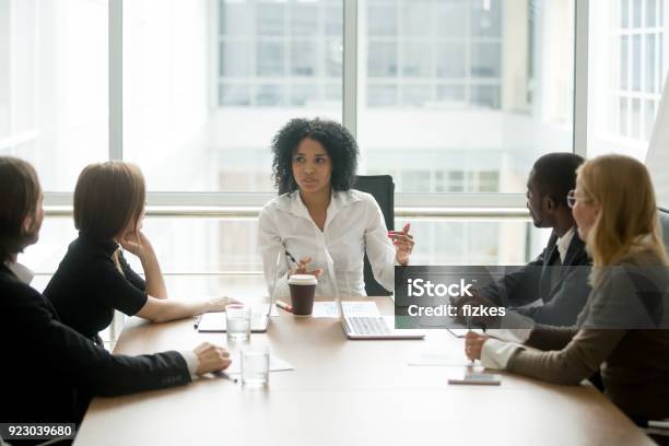 Black Female Boss Leading Corporate Meeting Talking To Diverse Businesspeople Stock Photo - Download Image Now