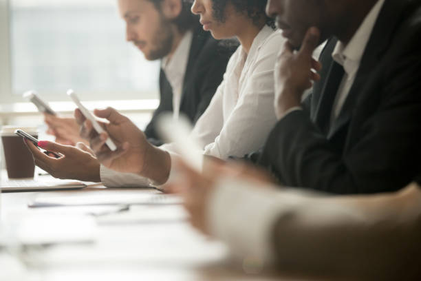 istock Diverse business people holding using mobile phones, close up view 923040160