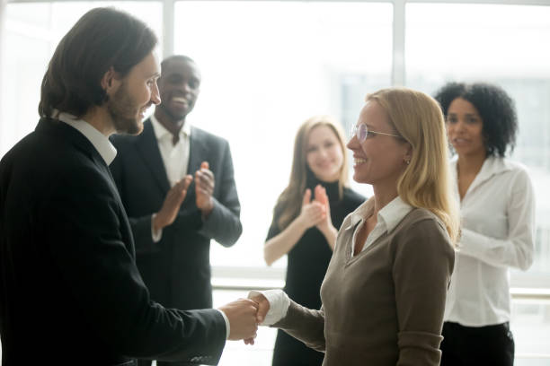 istock Boss handshaking employee congratulating with promotion while diverse colleagues applauding 923040758