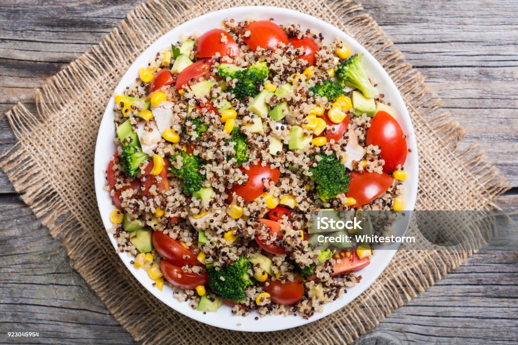 fresh quinoa salad Quinoa salad with tomatoes , avocado , broccoli and corn . Vegan superfood Quinoa Stock Photo