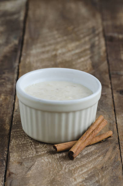 istock Rice with milk and cinnamon sticks on a wooden bottom. 923048972
