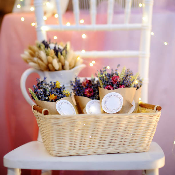 istock Beautiful dried flowers in paper boxes with lights on background 923055930