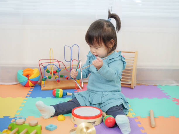 istock baby girl play triangle at home 923056498