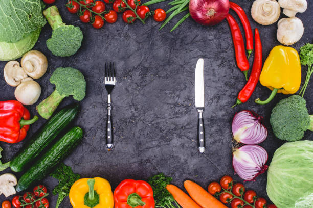 istock top view of fresh organic assorted vegetables and fork with knife on black 923058884