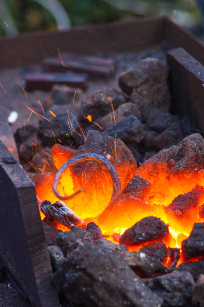 istock blacksmith furnace with burning coals, tools, and glowing hot metal workpieces 923062126
