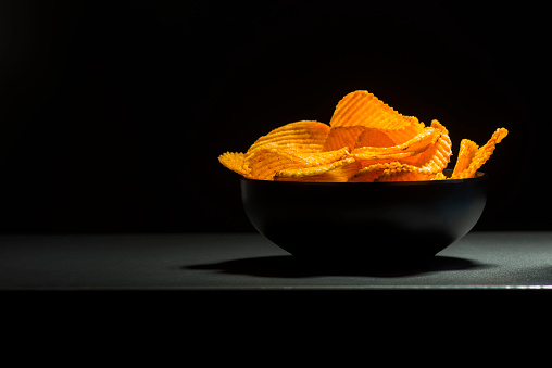 bowl of chips on dark background