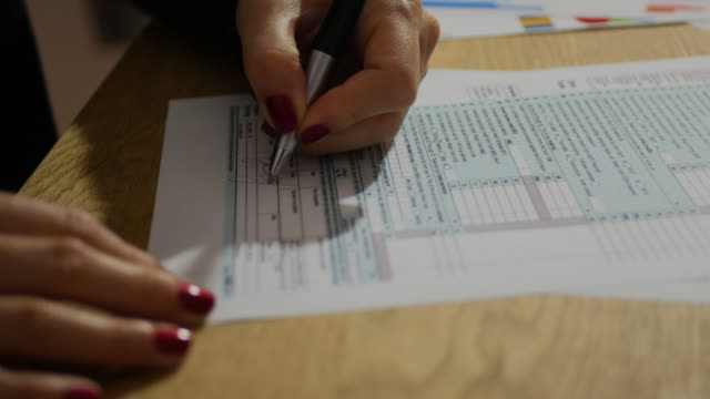 Taxation in USA and Tax Form 1040 - businesswoman filling out the document