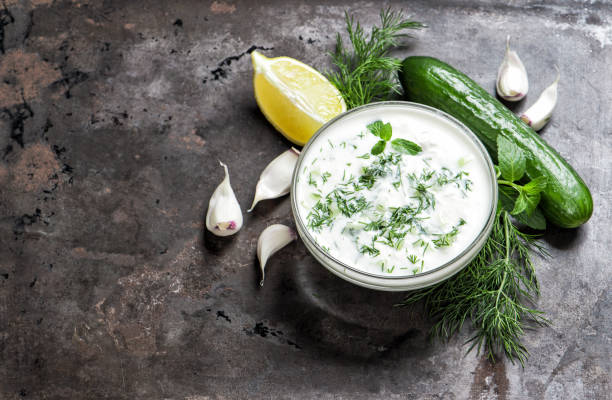 istock Tzatziki sauce herbs vegetables Food background 923065192