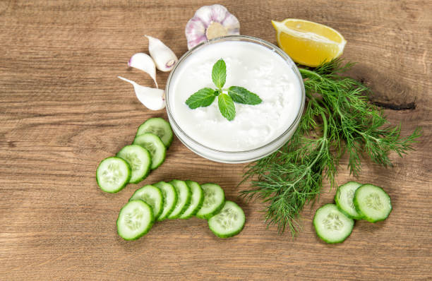 istock Tzatziki ingredients wooden kitchen table Yoghurt herbs vegetables 923065200